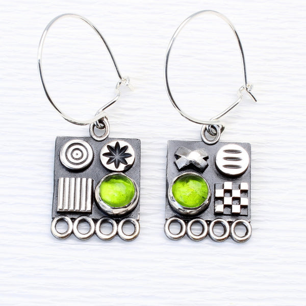 Square sterling silver earrings with 3D symbols and peridot gemstones by jewellers John and Dawn Field 