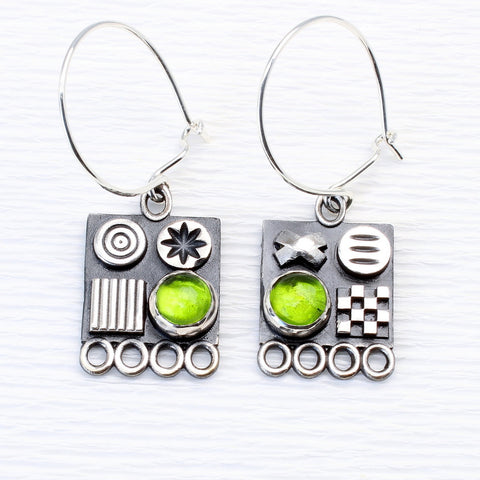 Square sterling silver earrings with 3D symbols and peridot gemstones by jewellers John and Dawn Field 