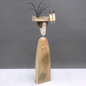 Driftwood sculpture of two birds sitting on a lady's hat by artist Lynn Muir