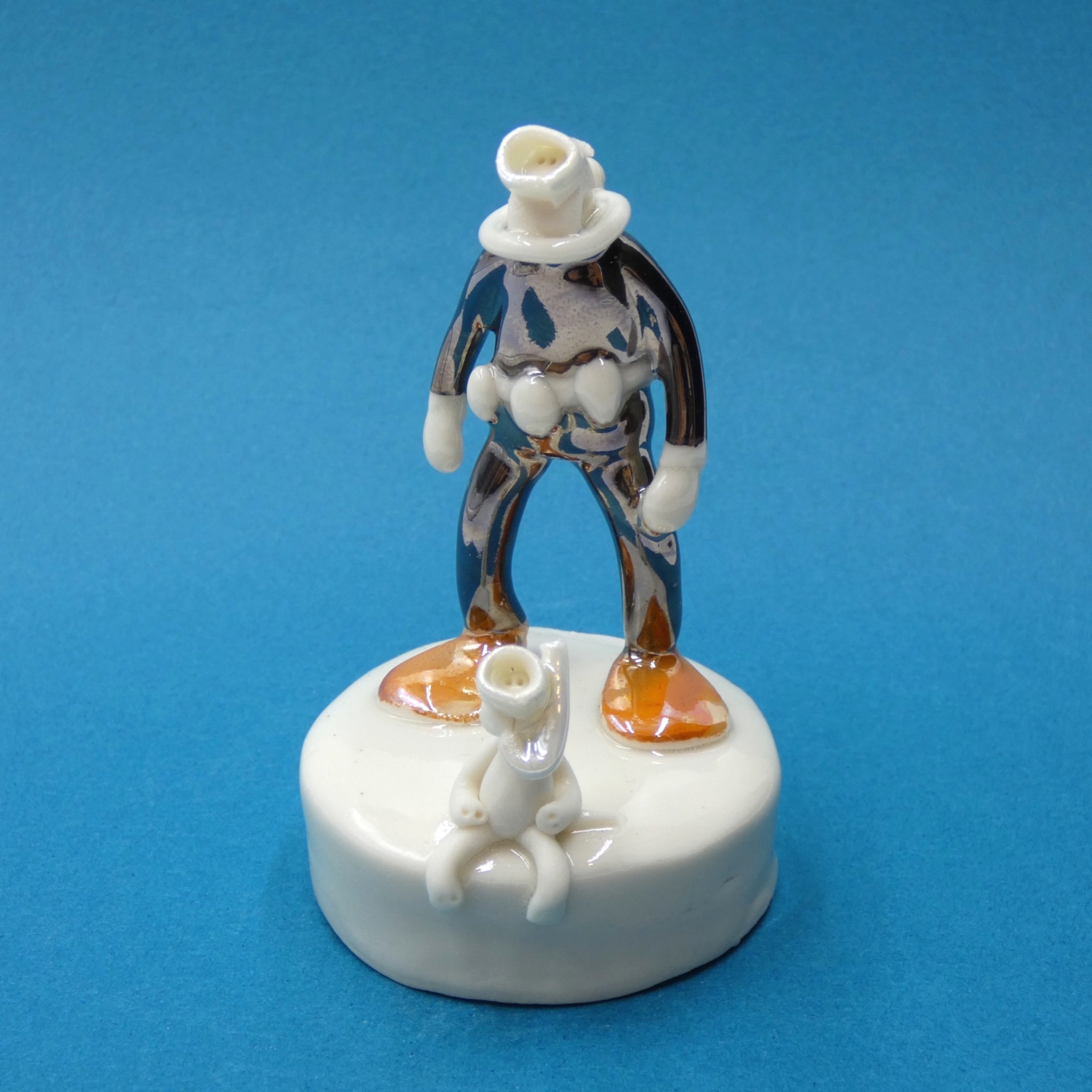 Porcelain sculpture of scuba diver and cat by artist Andrew Bull