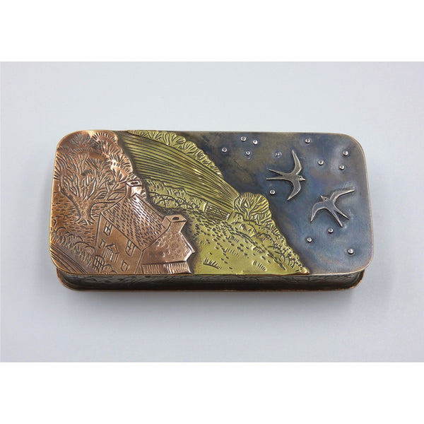Metal hinged box depicting swallows flying in the night sky over a farm by artist Cornelius Van Dop