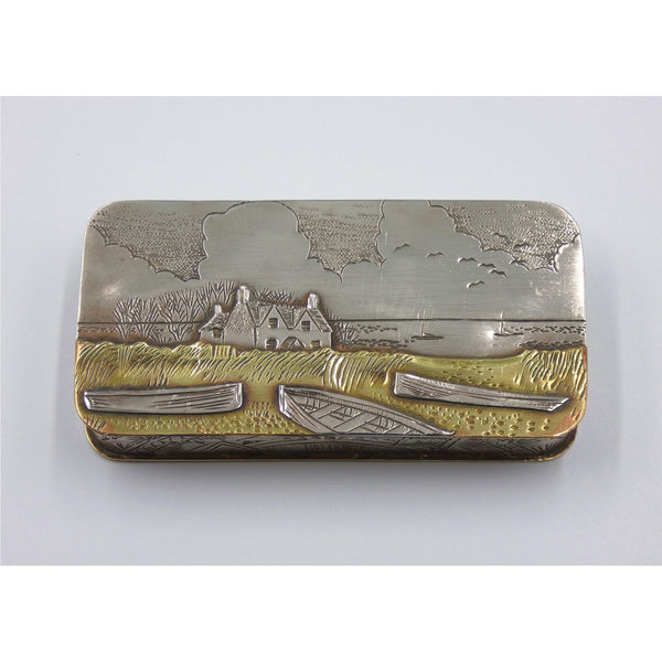 Metal hinged box depicting a house and boats near the ocean by artist Cornelius Van Dop