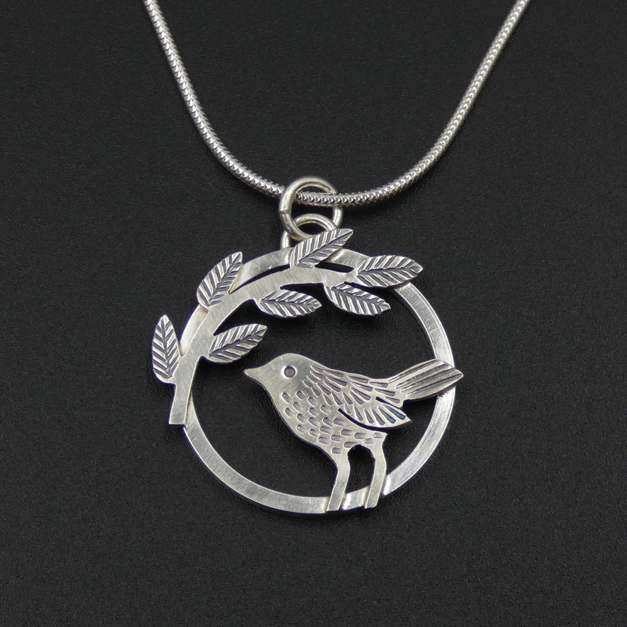 Bird and leaves circle pendant by jeweller Helen Shere