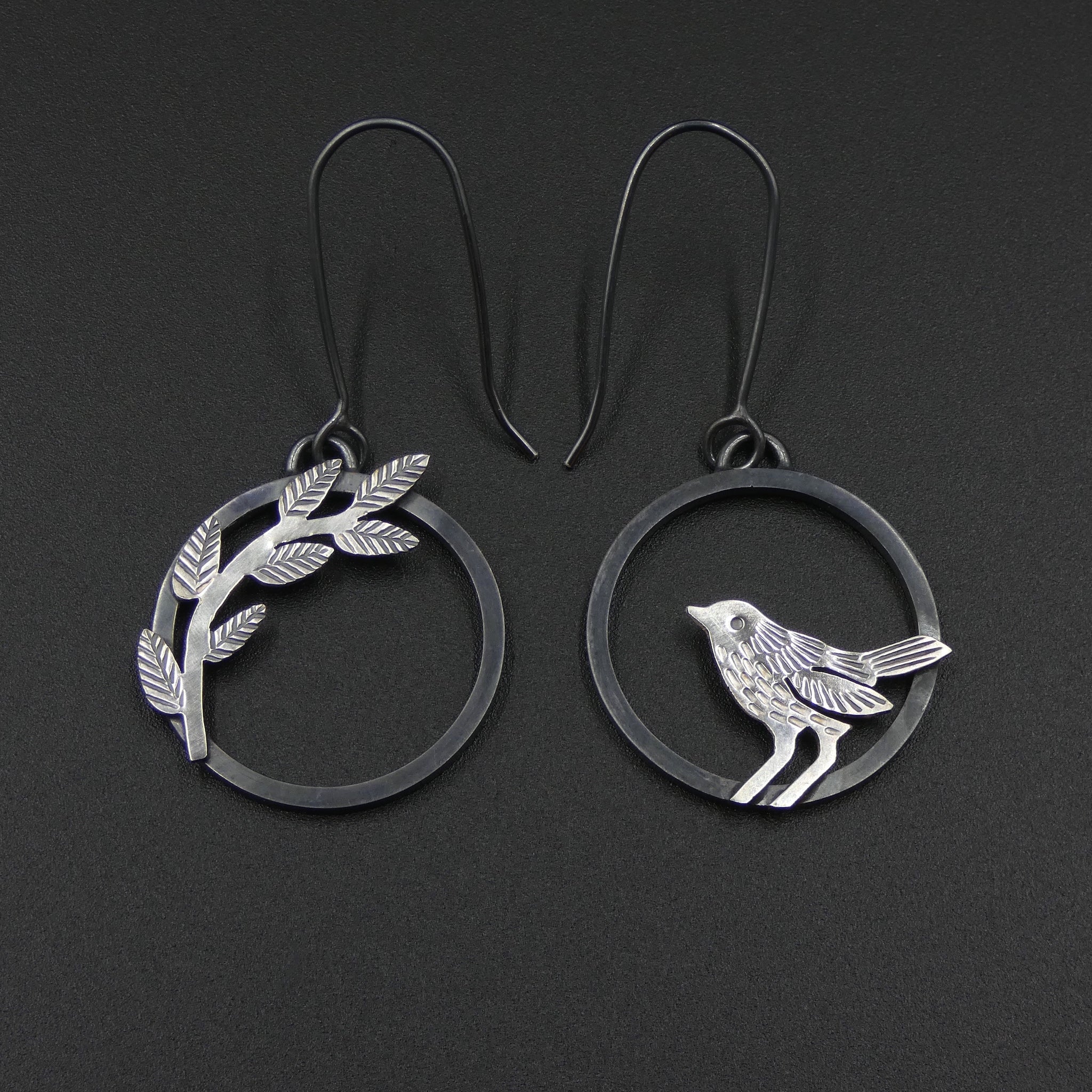 Mismatched bird and leaves earrings by jeweller Helen Shere