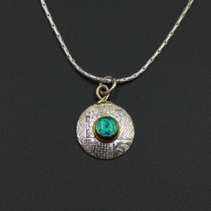 Small round pendant by jewellers John and Dawn Field
