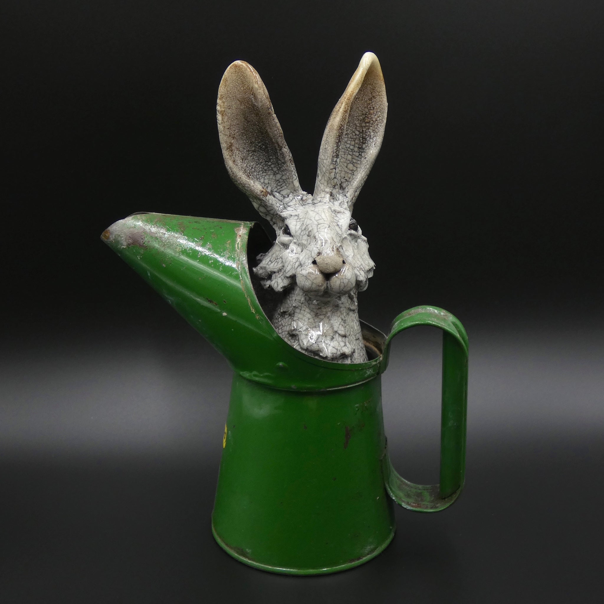 Sculpture of a hare hiding in an oil jug by artists Richard Ballantyne and Carol Read